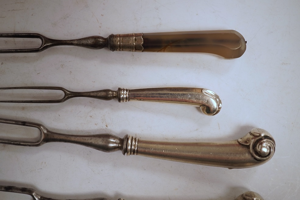 Five assorted George pistol handled steel pronged forks, four with white metal handles and one with agate handle, together with two similar mother of pearl handled steel pronged forks, largest 20.5cm and a small agate ha